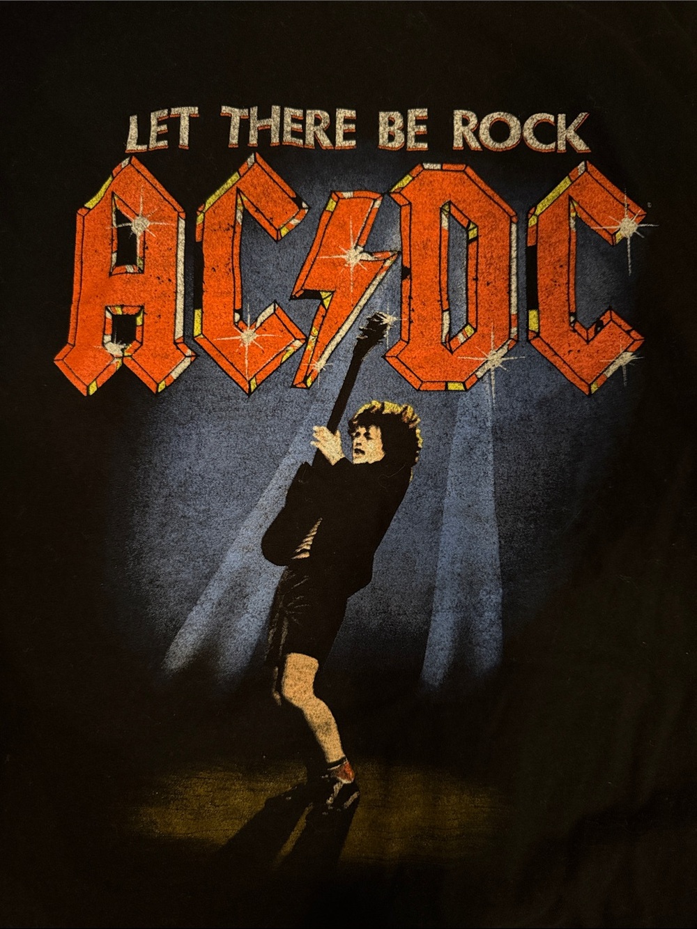 AC/DC Black Tee with Orange Logo and Blue Spotlight Graphic